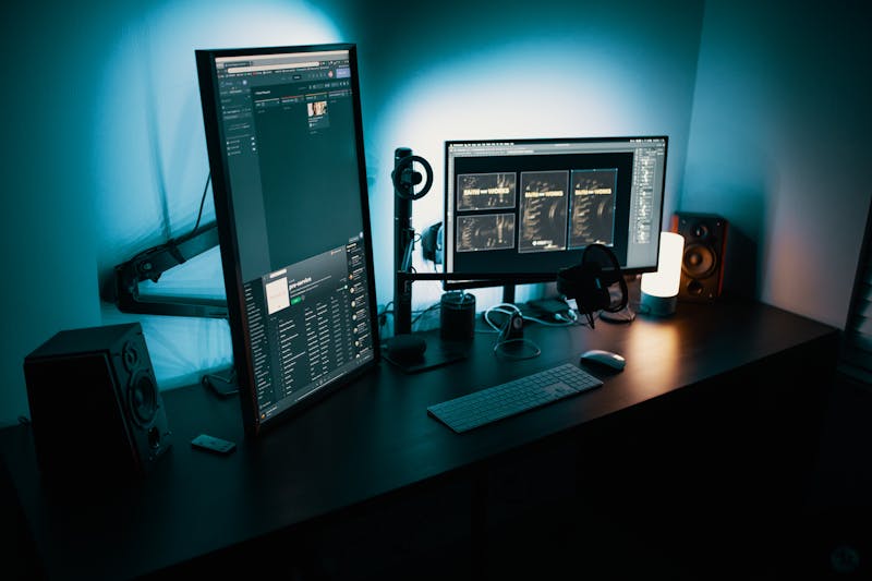 Gaming desk setup with monitors and ergonomic chair for extended gaming and work sessions