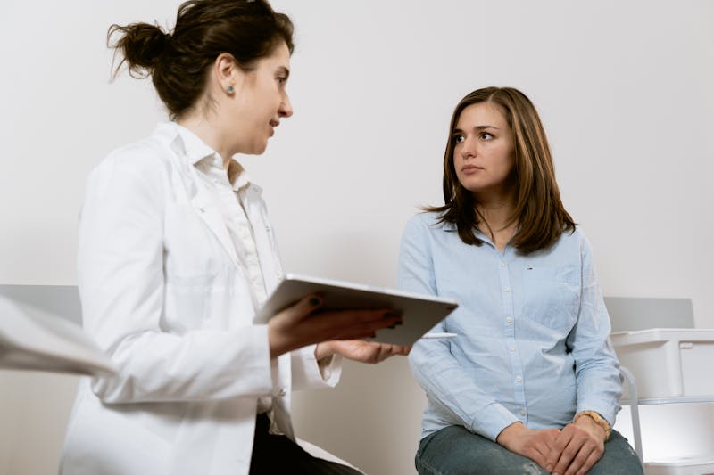 Doctor reviewing patient health data from wearable device on digital platform
