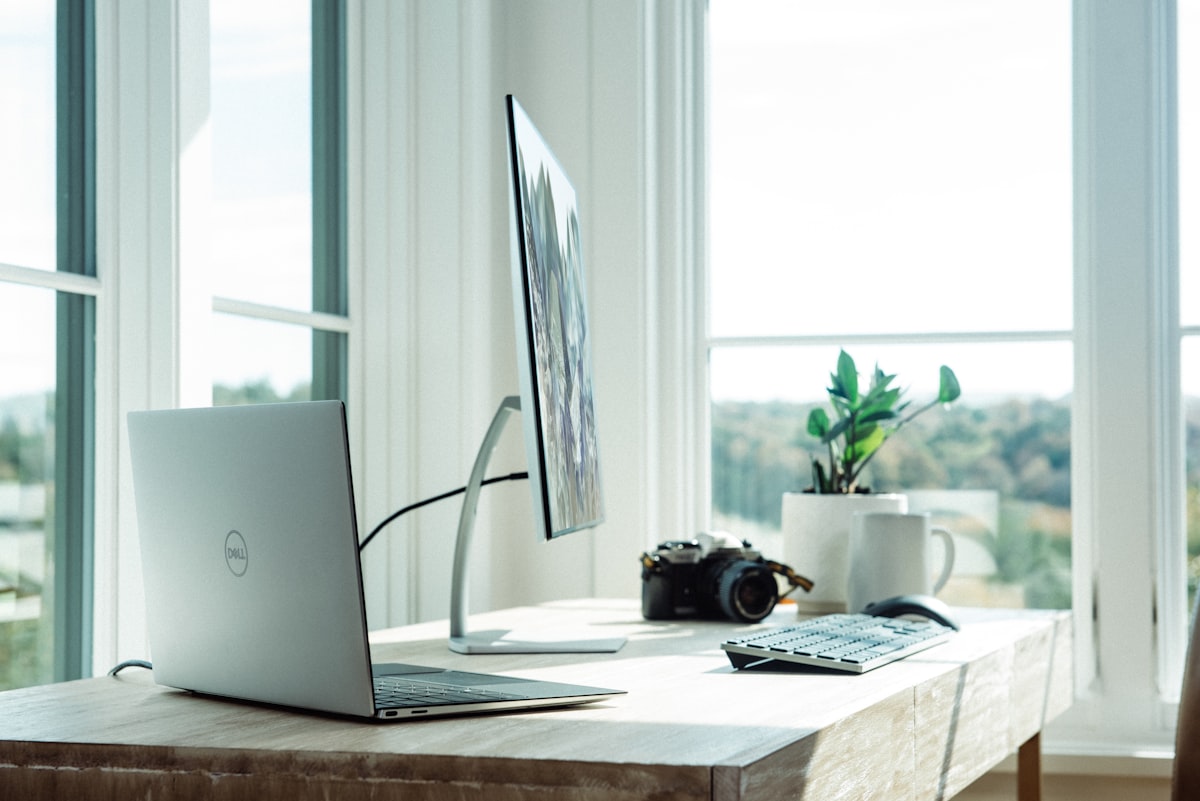 Person reviewing AI agent output on laptop screen in modern office environment