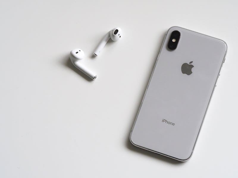 MagSafe wireless charger attached to iPhone showing magnetic snap connection for easy charging