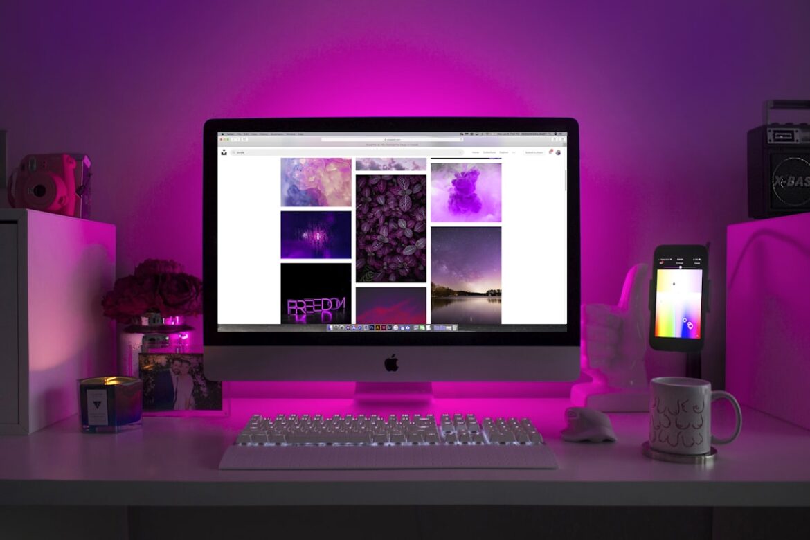 Person using mechanical keyboard and dual monitor setup for productivity