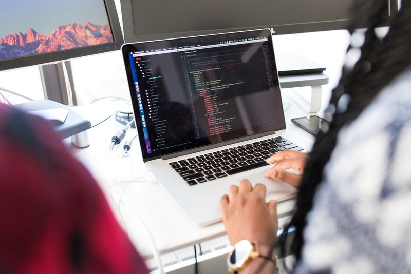 Developer working on multi-cloud architecture with multiple provider dashboards