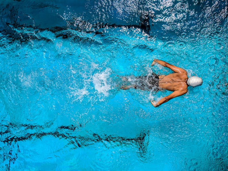 Athlete using technology to track cross-training performance across swimming, cycling, and running