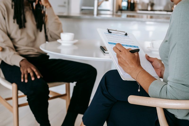 Person using an AI therapy chatbot on smartphone for mental health support