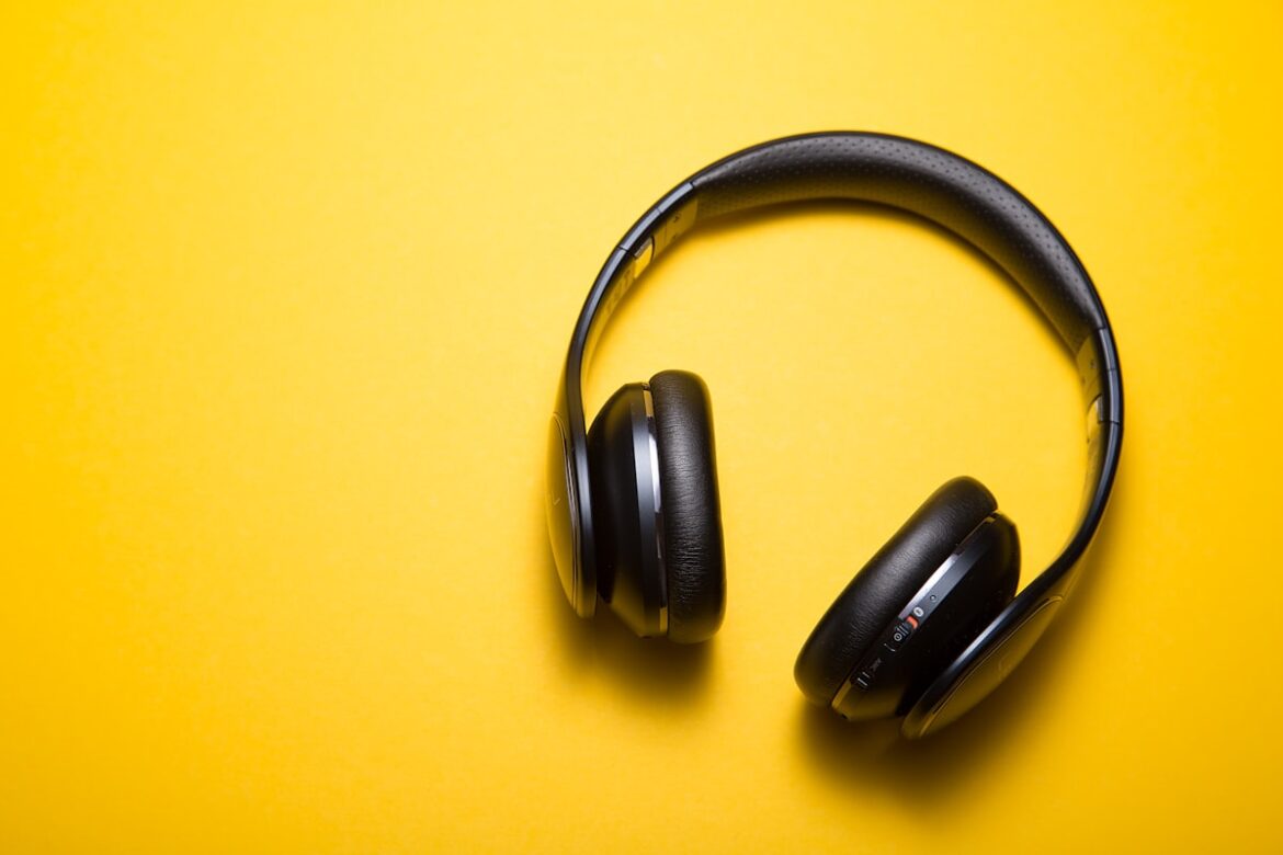 Wireless earbuds and headphones on a clean surface showing audio tech
