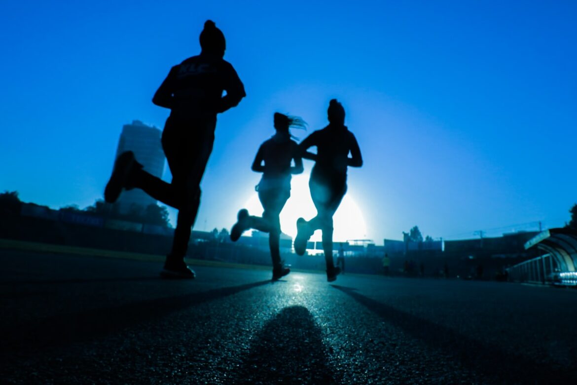 Woman running outdoors on a trail in the morning for fitness and health