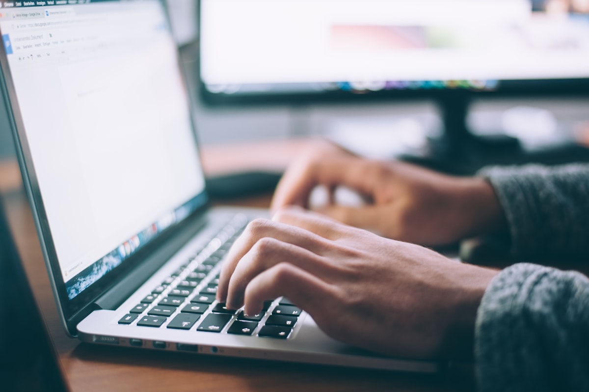 Person using Google Search on laptop browsing AI overview results internationally
